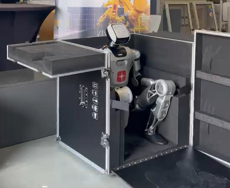 Humanoid robot staffer in a box